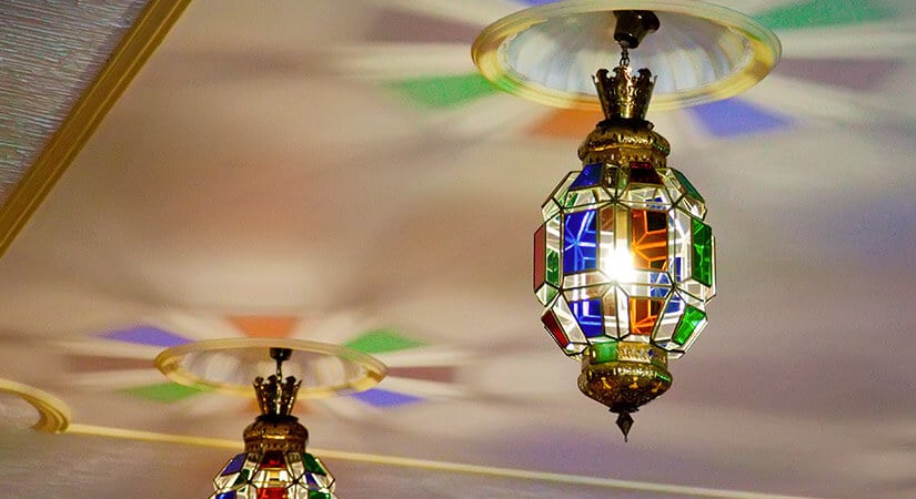 Unique stained glass light fixtures with gold detailing.