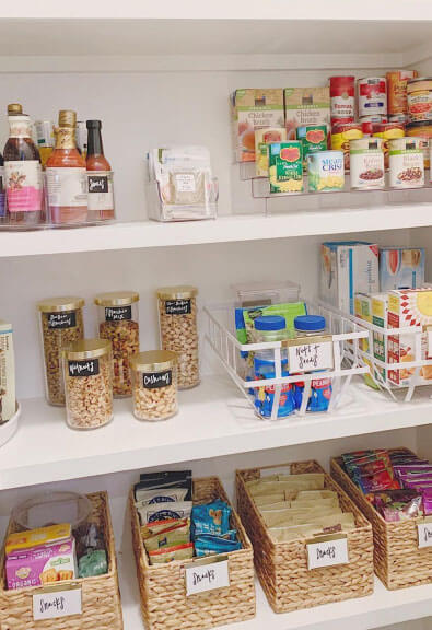 Pantry organization with baskets and custom labels.