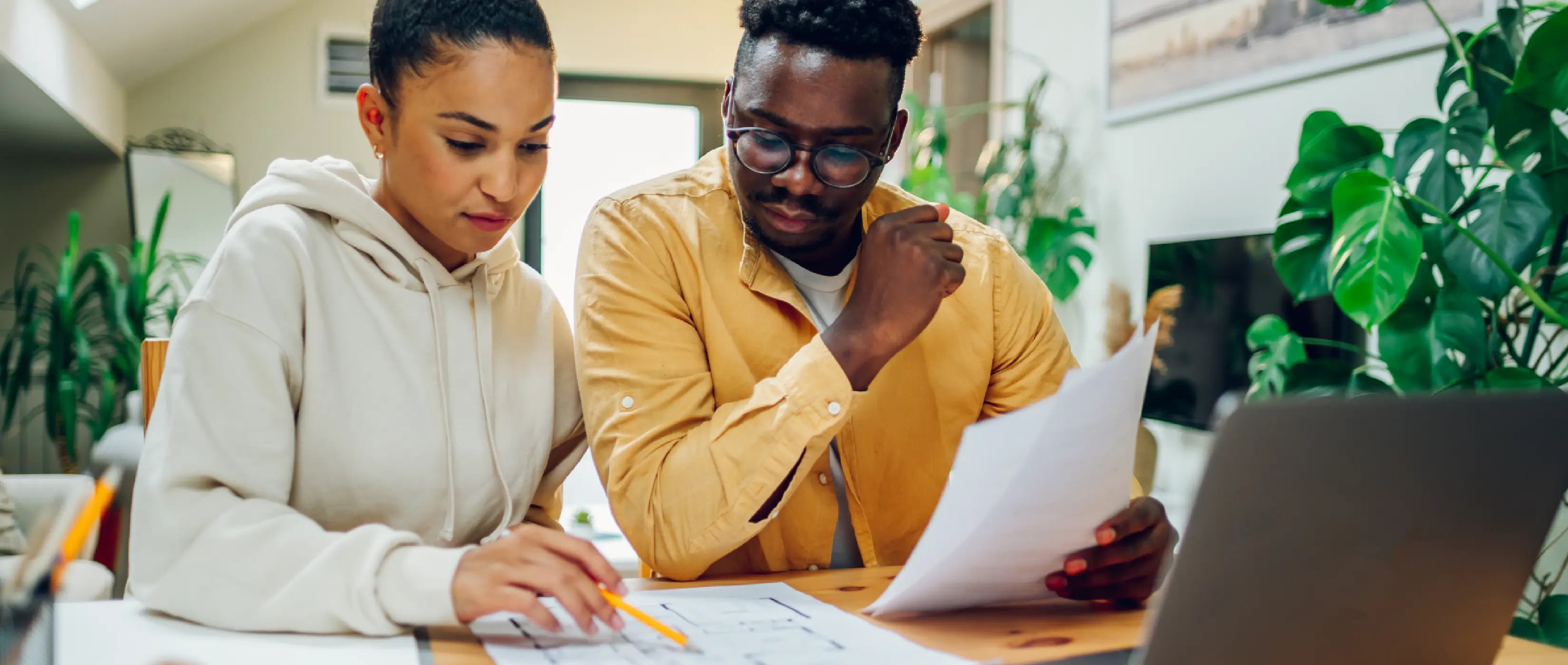 Couple researching kitchen remodel costs on computer.