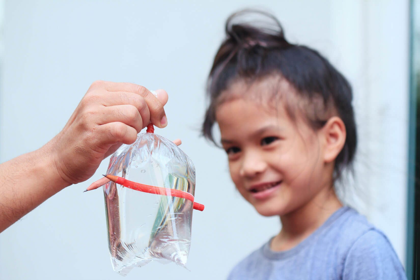 Child looking at leakproof water bag science experiment.