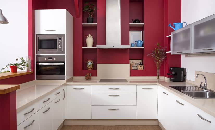A white kitchen with red backsplash, a trendy kitchen design idea for 2023