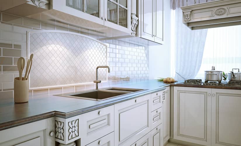 An all-white kitchen with an arched tile backsplash, a top kitchen design trend