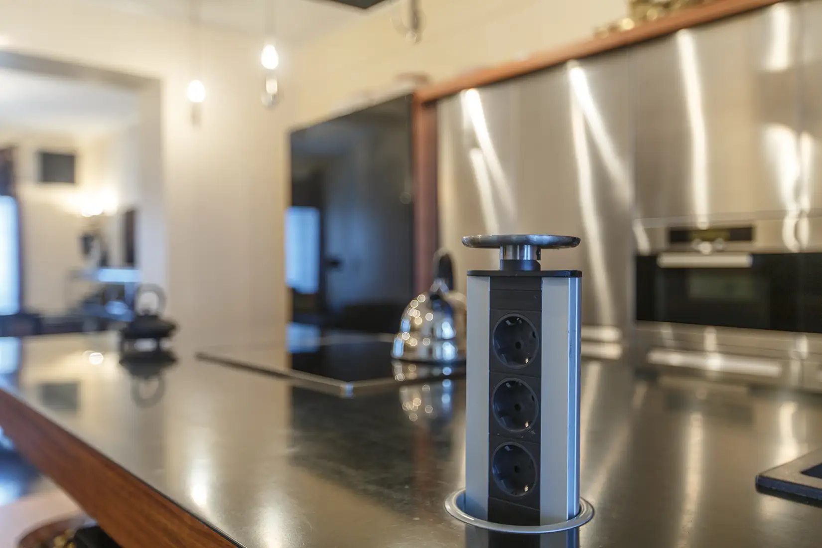 Close up of hidden pop up outlet in kitchen counter.