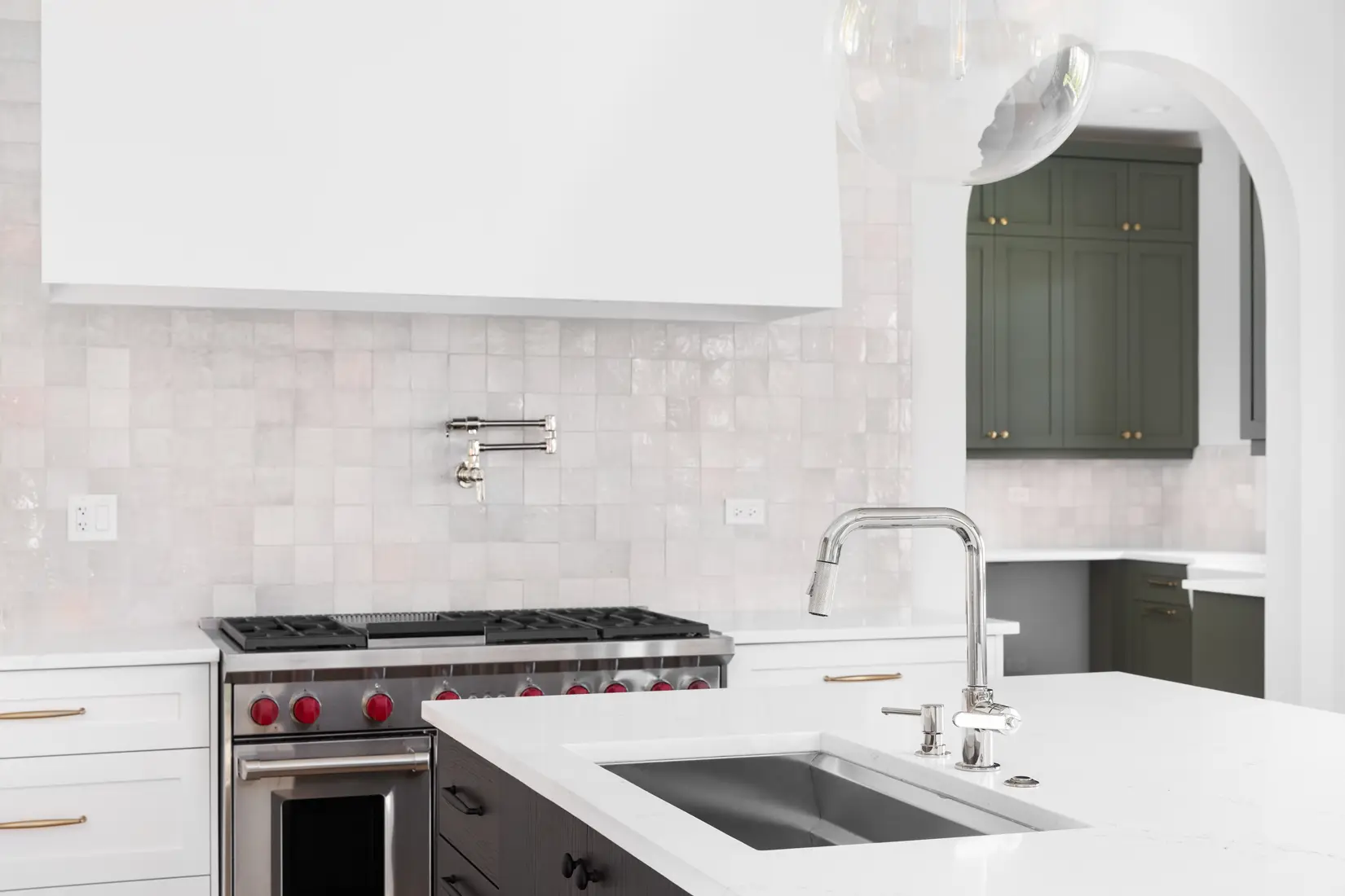 Kitchen with white man-made tile backsplash.