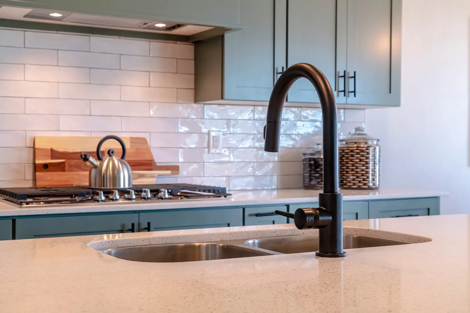 Kitchen with matte black sink faucet and cabinet hardware.