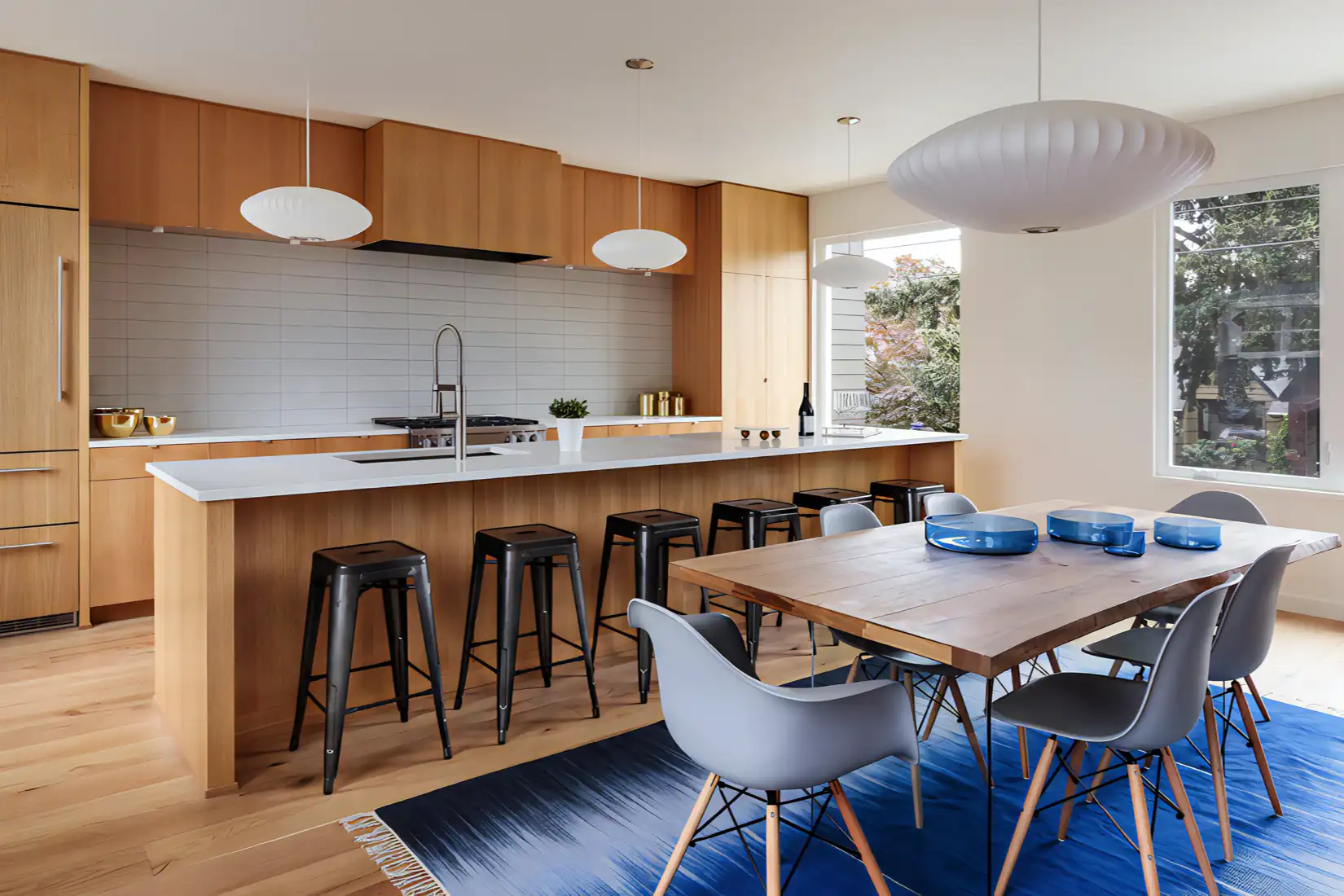 A kitchen design featuring subway tile backsplash and wood cabinets.
