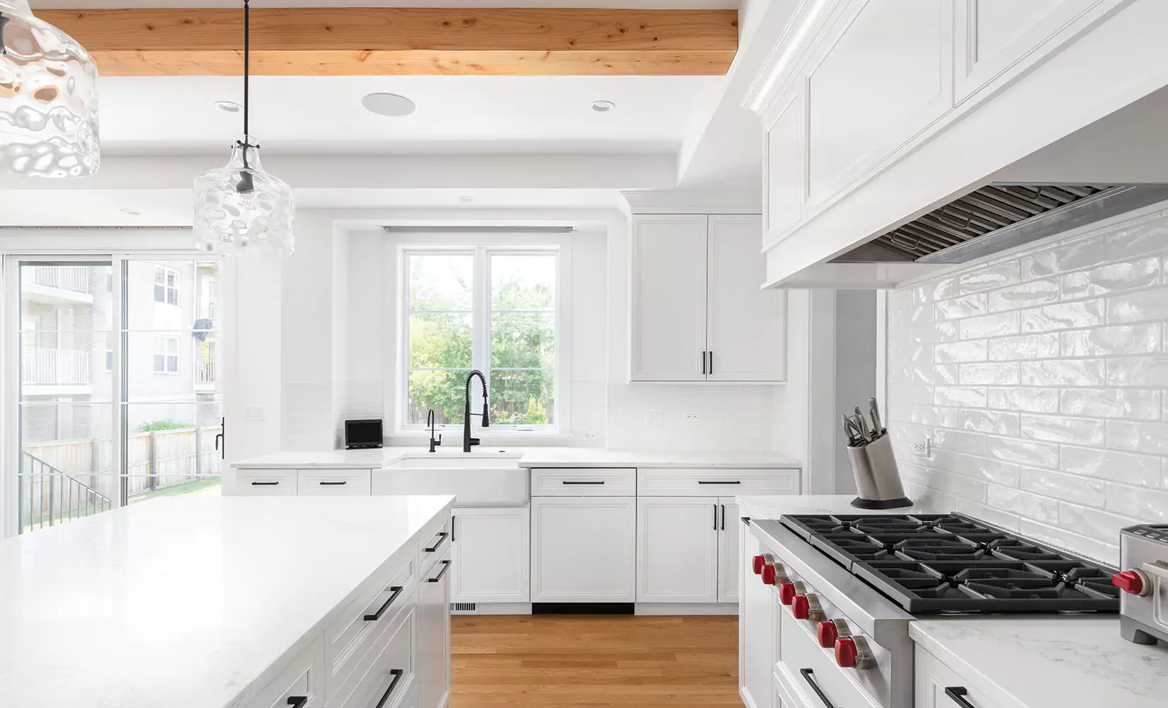 White L-shaped kitchen with doorway in center of layout.