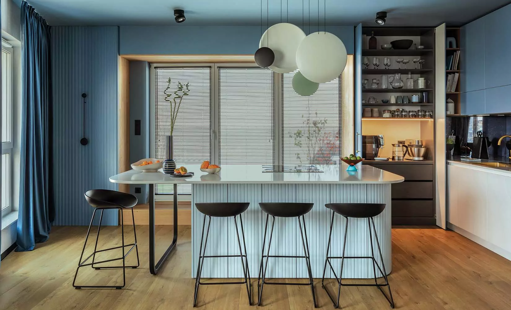 Kitchen island in L-shaped kitchen with wrap-around seating.