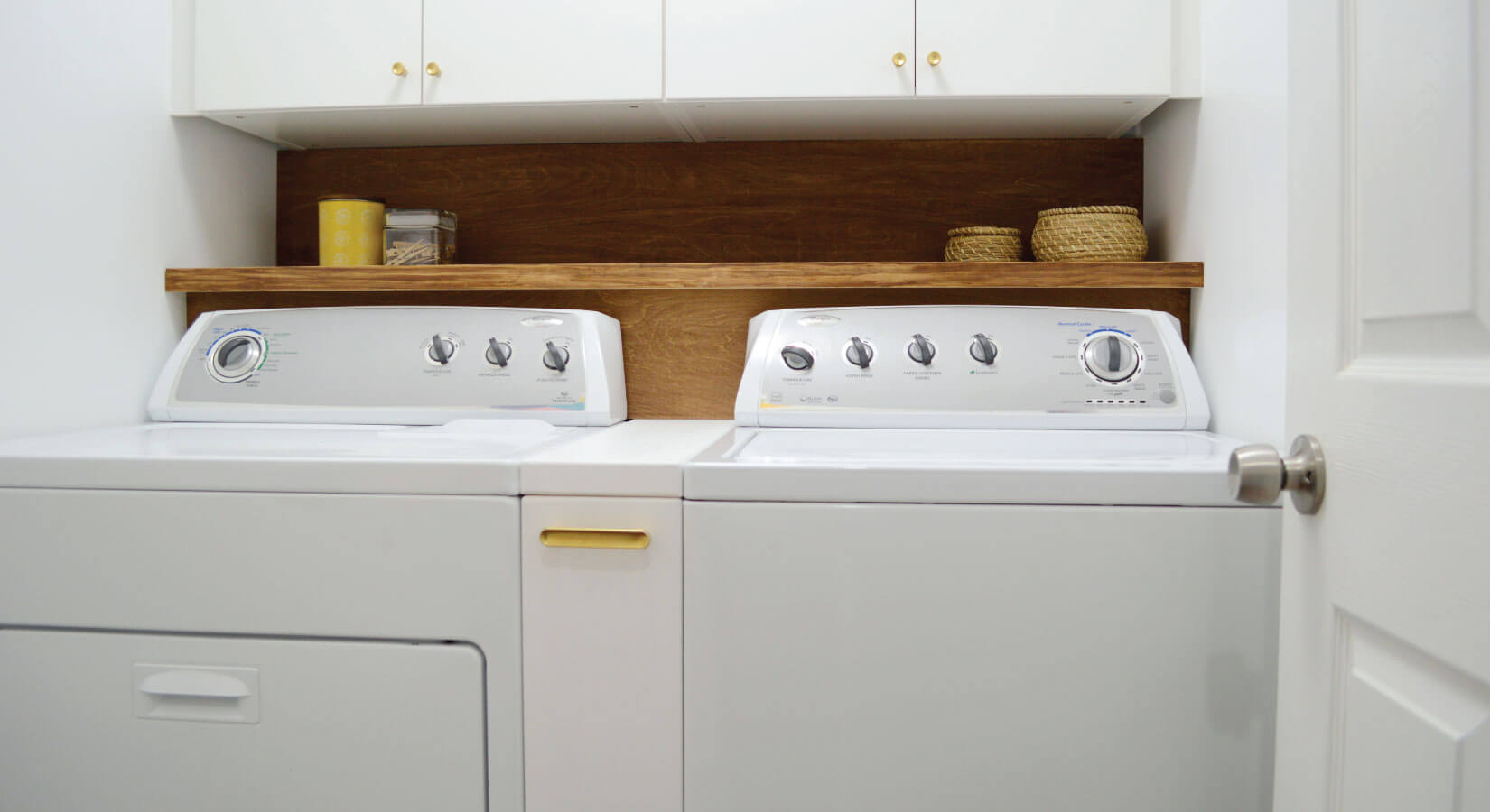 White washer and dryer with custom pull-out cabinet in between.