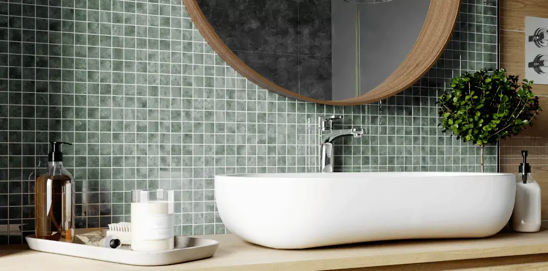 Bathroom backsplash with small, light green tiles.
