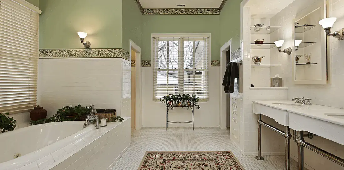 Traditionally-decorated bathroom with sage green walls.