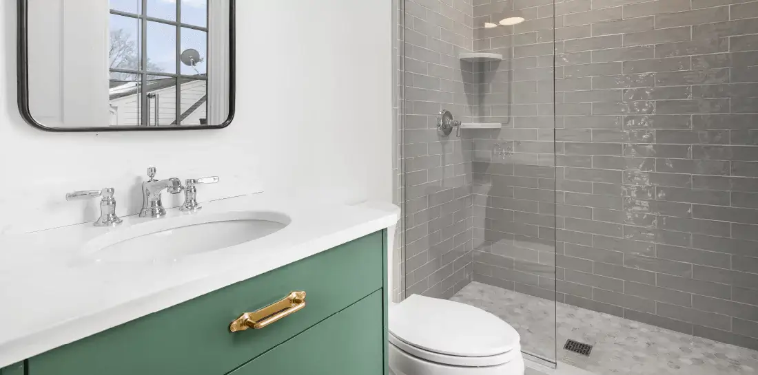 Neutral bathroom with a green vanity.