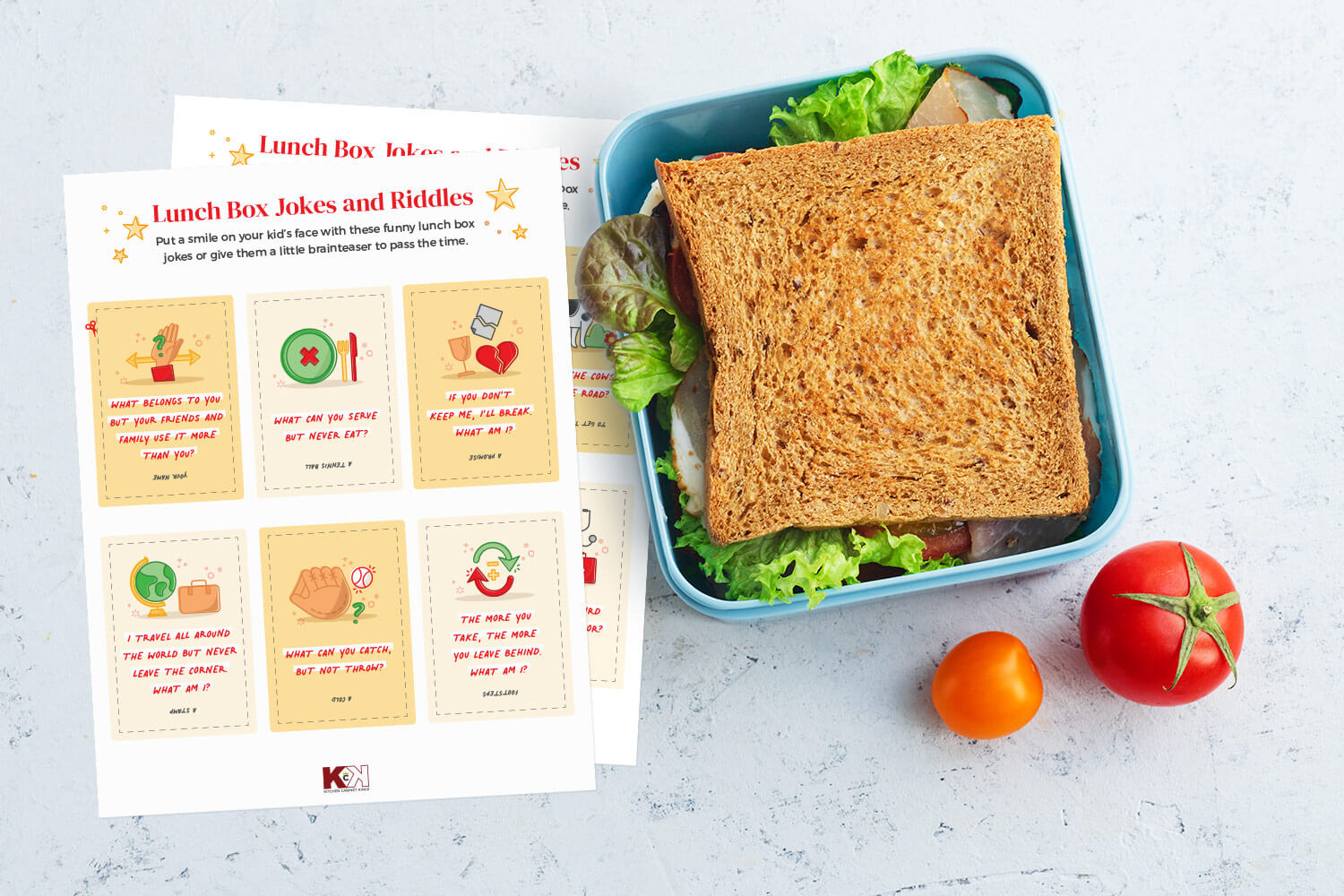 Printable lunch box jokes and riddles next to a sandwich on a white countertop.