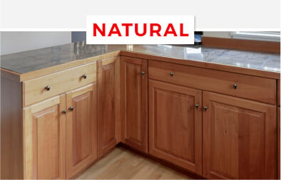 Maple wood kitchen cabinets with a natural finish in a ranch-style kitchen.