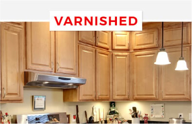 Varnished maple kitchen cabinets with a classic honey color.