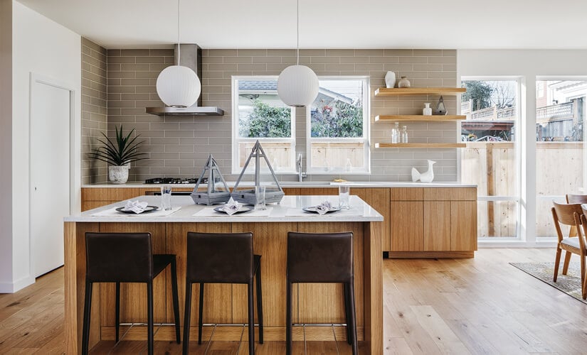Mid-Century Modern kitchen with natural wood cabinets and large central window over sink.