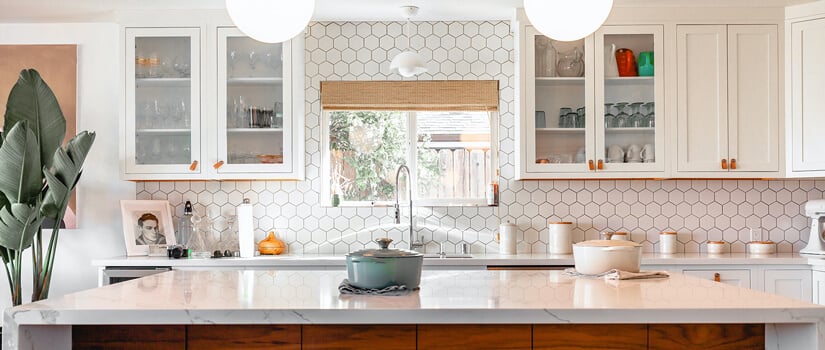 Mid-Century Modern kitchen with white honeycomb backsplash and marble countertops.