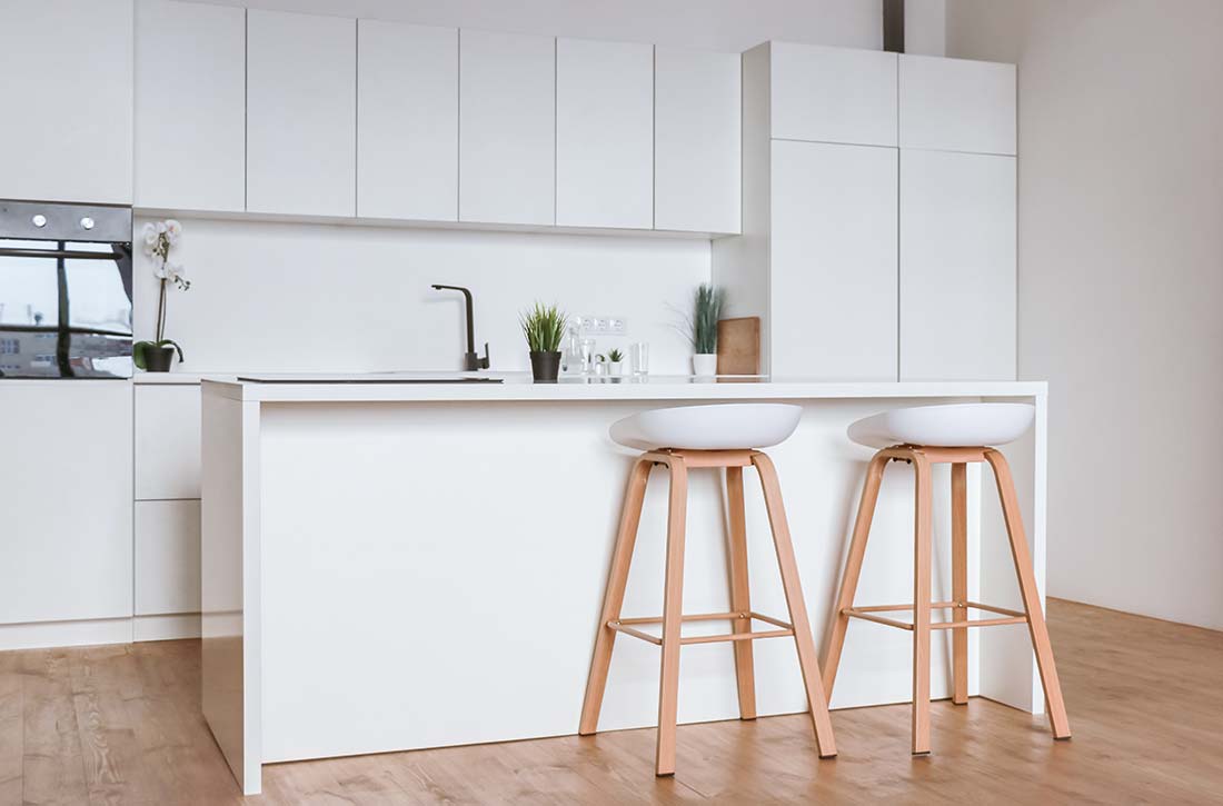 Minimalist bar stools in white kitchen.