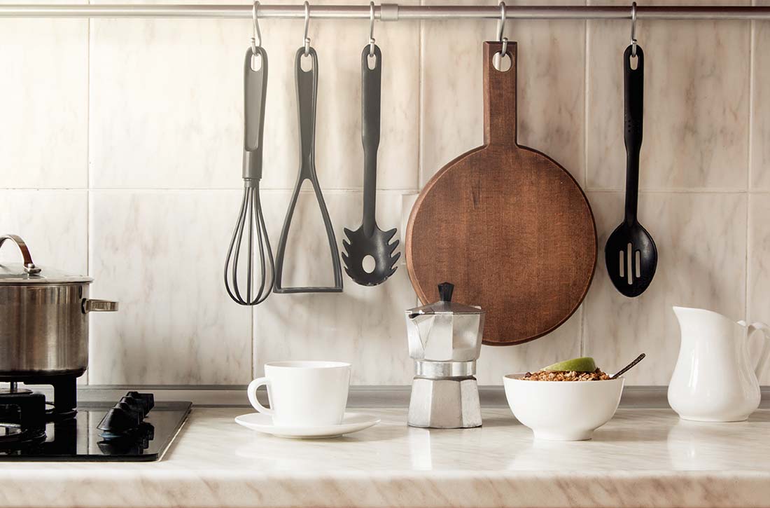 Pots, pans, and cooking utensils hanging above countertops.