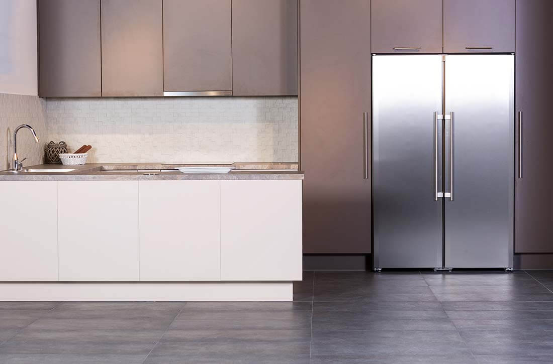 Deep and standard upper cabinets in a modern kitchen.