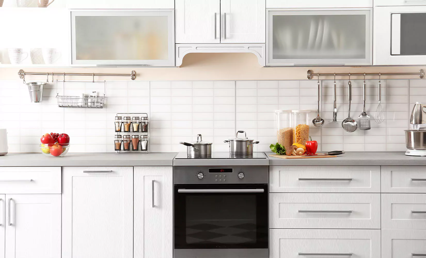 One-wall kitchen with racks to hang utensils next to stove.