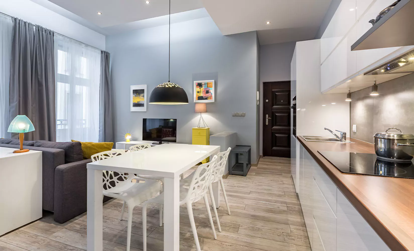 Modern studio single-wall kitchen with under cabinet lighting.