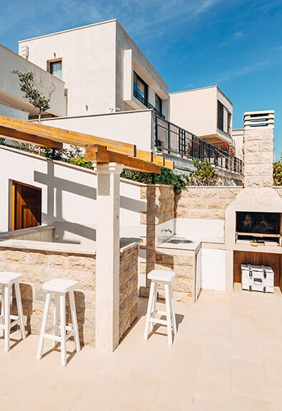 Bright contemporary outdoor kitchen with wood burning oven.