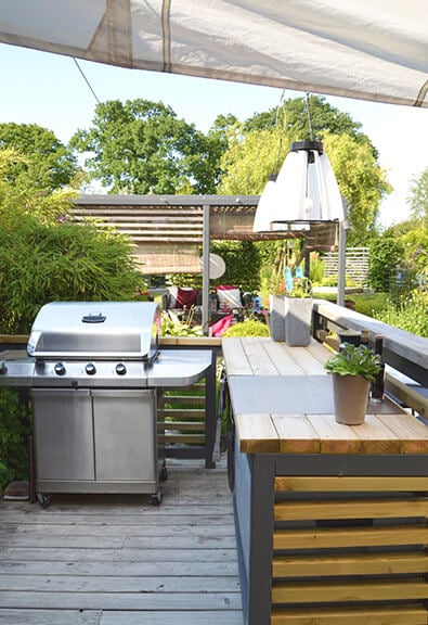 Outdoor kitchen with stainless steel grill.