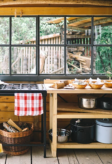 Rustic outdoor kitchen in a wooden shack.