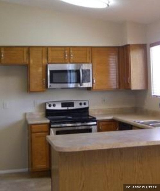 Wood cabinets with stainless steel appliances