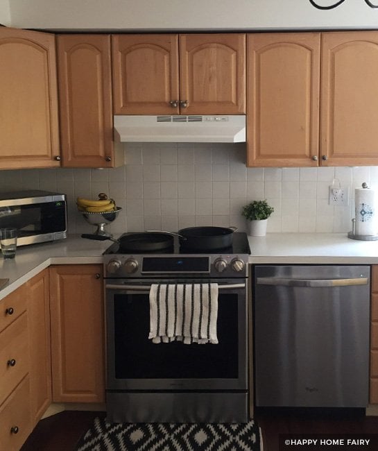 Wood kitchen cabinets with white tile backsplash