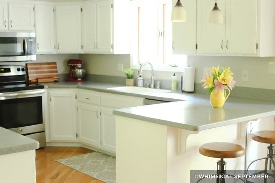 White painted kitchen cabinets with gray countertop