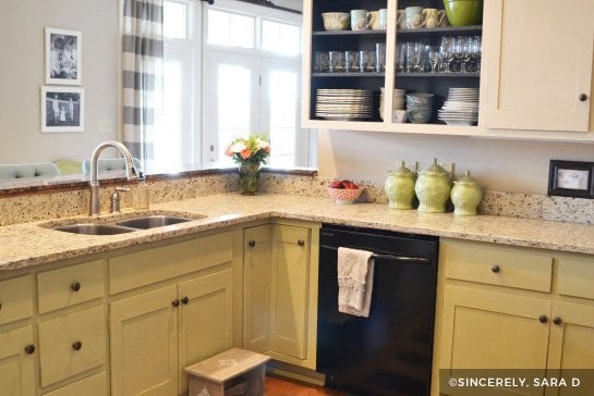 Green kitchen cabinets with granite countertop