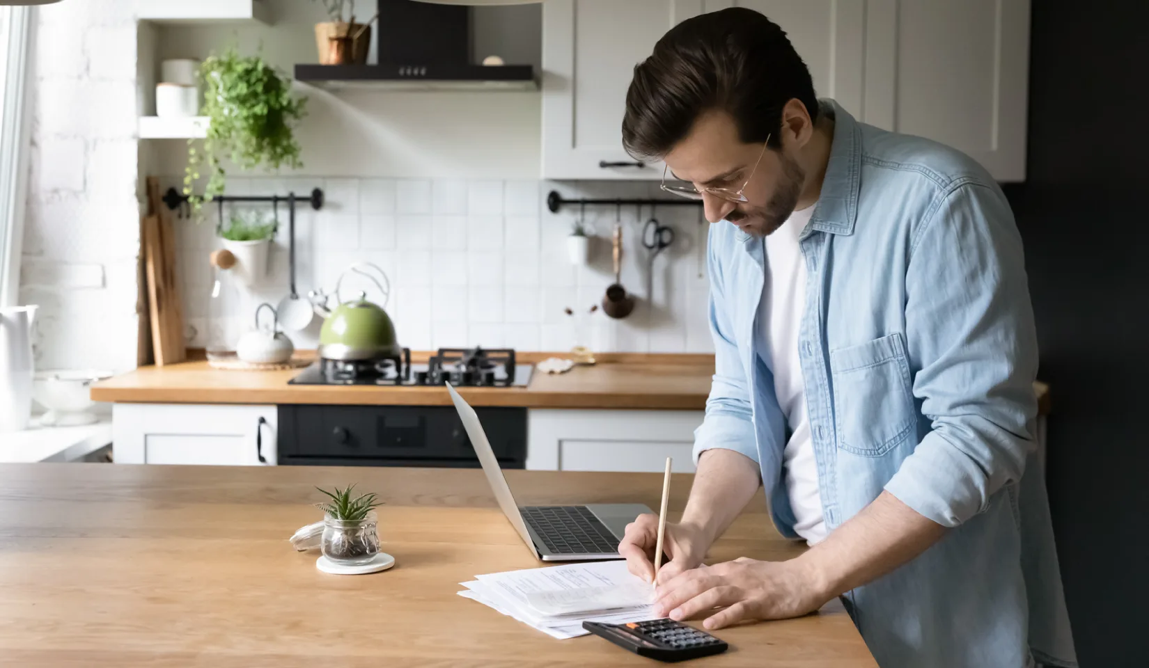 Person filling out house paperwork.