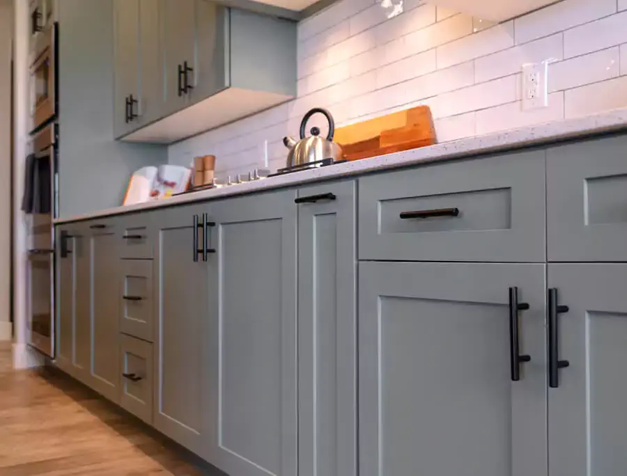 light grey kitchen with black handles