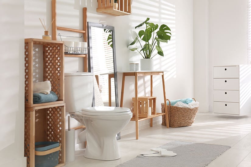 Bathroom with added over-the-toilet storage and lattice shelves.