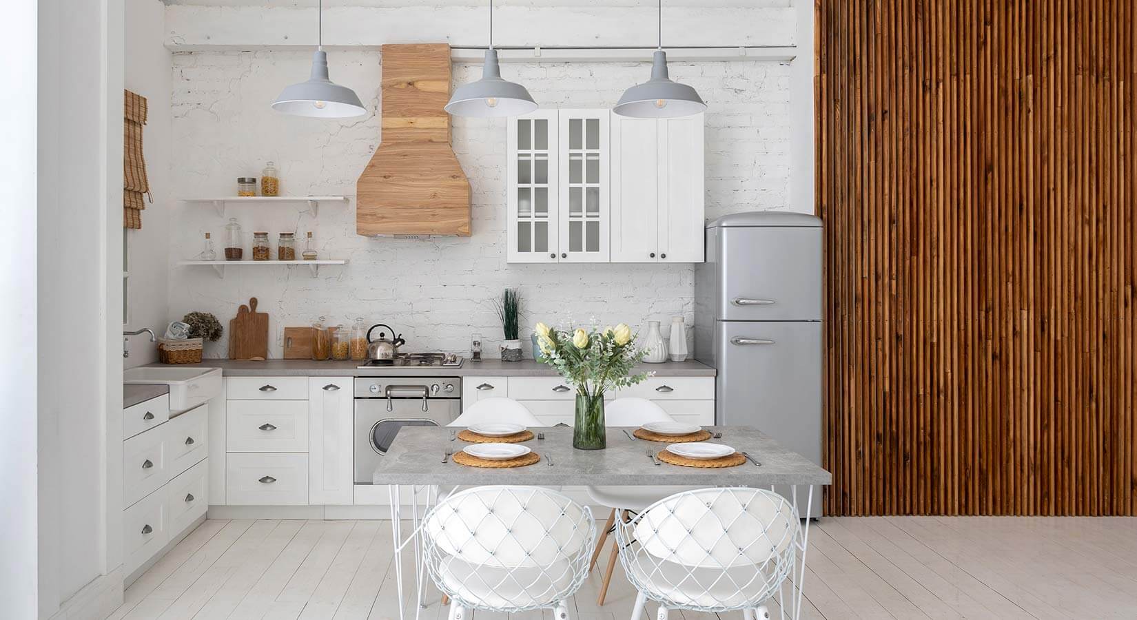 Small white kitchen with slat wood accent wall.