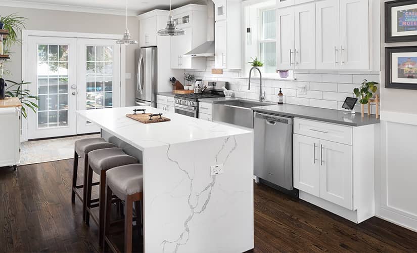 Transitional style kitchen with marble waterfall countertop.