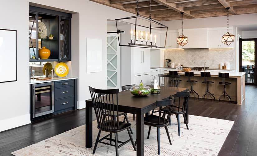 Transitional style kitchen and dining room with statement pendant lighting.