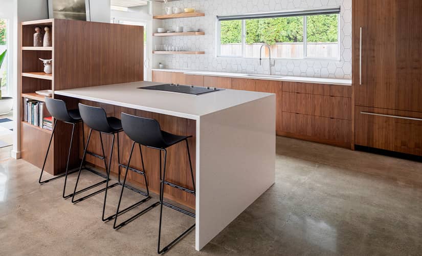 Transitional kitchen design with stained concrete floors.