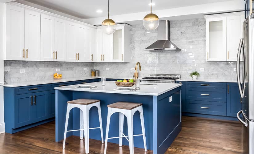 Transitional kitchen design with two-tone dark blue and white cabinets.