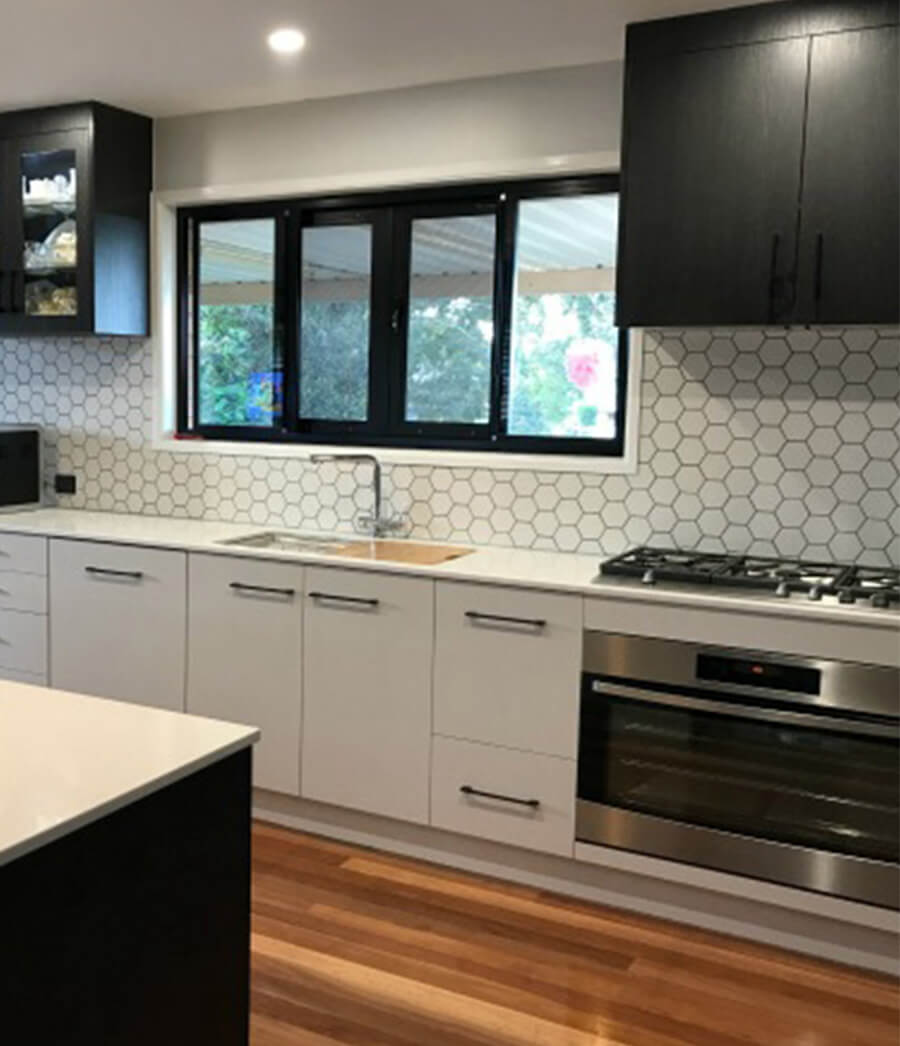 Two tone black and white kitchen cabinets.