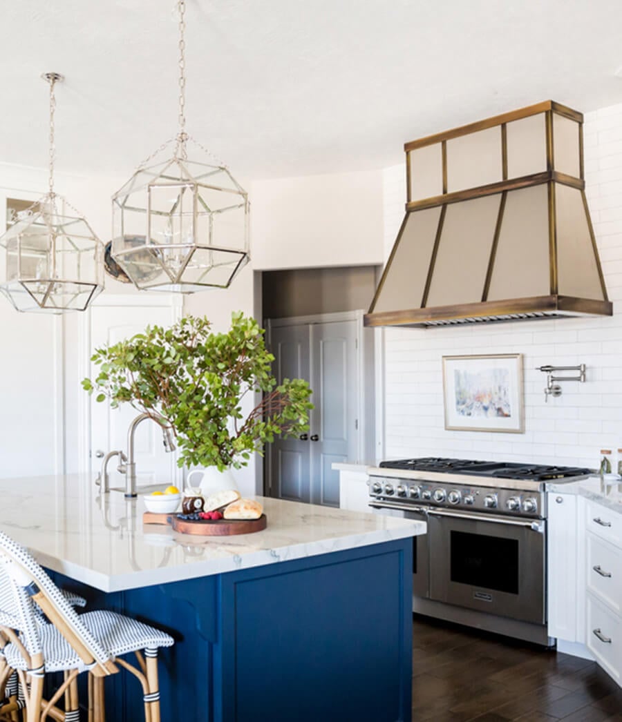 Two tone kitchen cabinets with a nautical island.