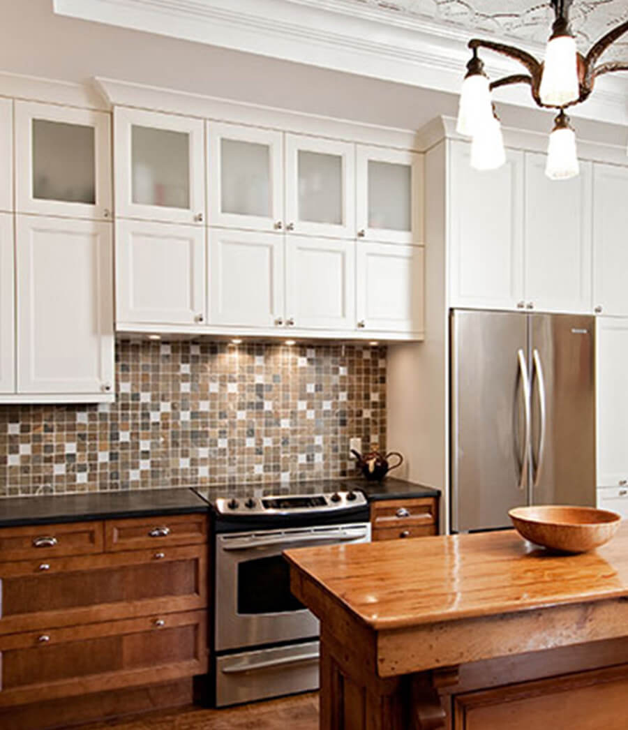 Two tone kitchen cabinets with patterns.