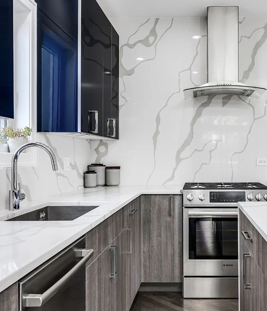 Two-tone kitchen with marble countertop and backsplash