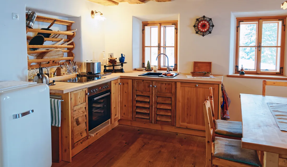 Rustic kitchen with wood louvered kitchen cabinets.