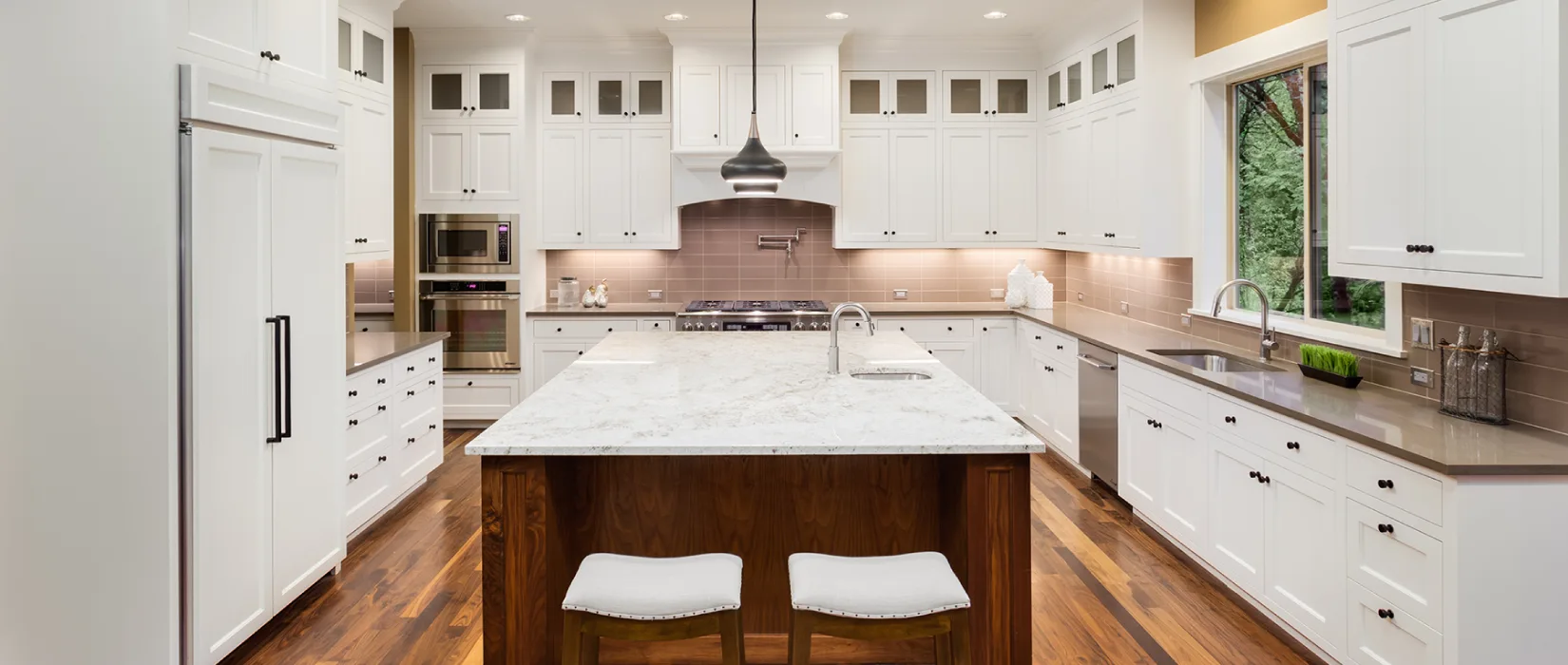 Kitchen with updated white kitchen cabinets.