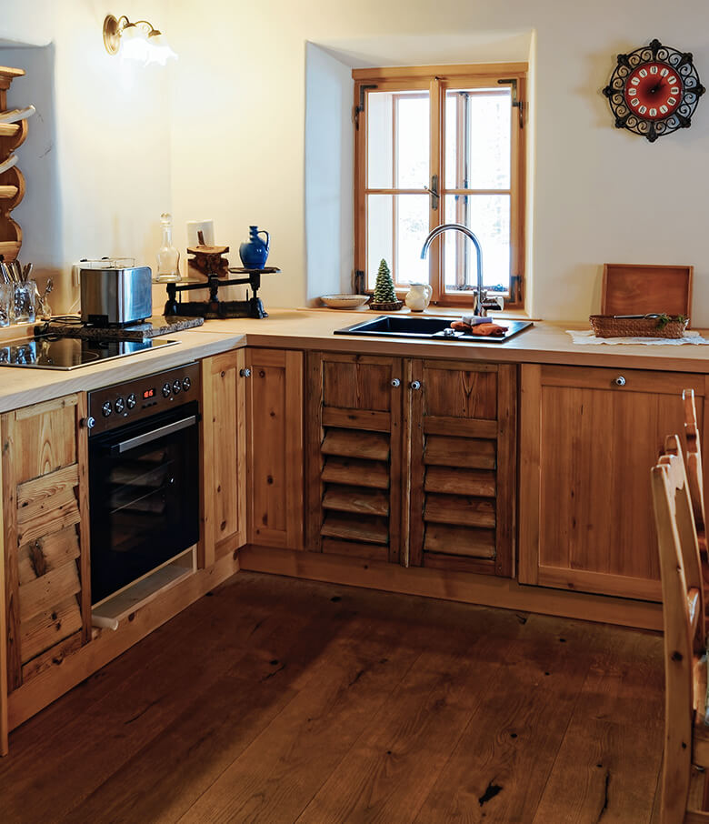 Louvered base cabinet in rustic farmhouse kitchen.