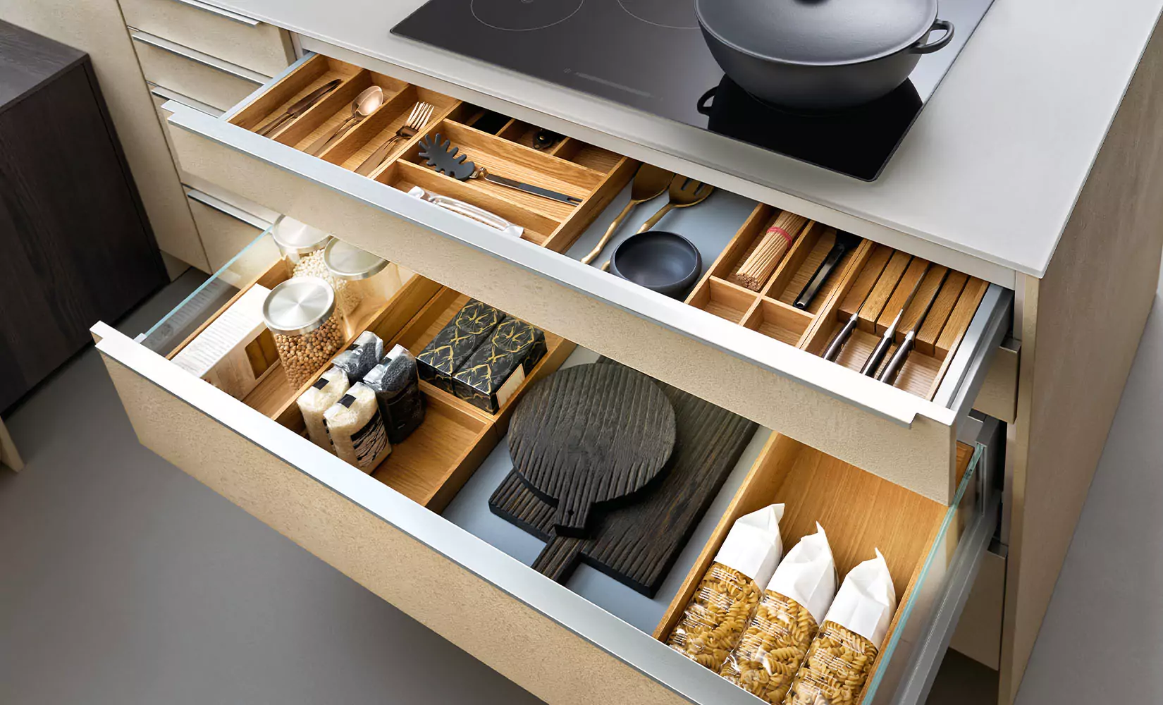 Organized kitchen drawer with storage inserts.